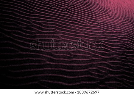 Red-blue colored shaded sands of the desert. Background and texture for modern design