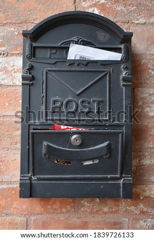 envelopes waiting in the postbox. vertical photo