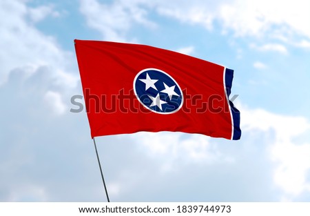Flag of Tennessee in front of blue sky