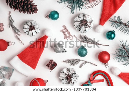 Christmas composition with New Year decorations, balls, stars, tree, Santa hat, spruce branches and sweets on white background. View from above. Holiday, winter concept. Flat lay, top view, copy space