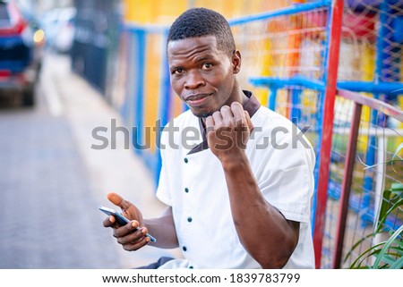image of african guy, with smart phone- outdoor concept 