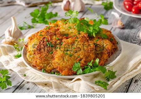 Fresh potato food, crispy pancakes fried on pan with garlic