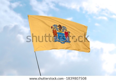 Flag of New Jersey in front of blue sky