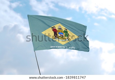 Flag of Delaware in front of blue sky