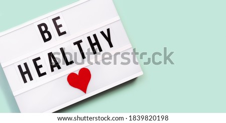 Lightbox with words Be Healthy on blue colored background. Care of health and medical concept. World health day. View from above.