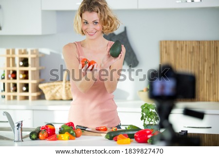 woman recording video in her home kitchen