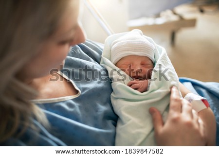 Mother with her newborn baby at the hospital a day after a natural birth labor Royalty-Free Stock Photo #1839847582