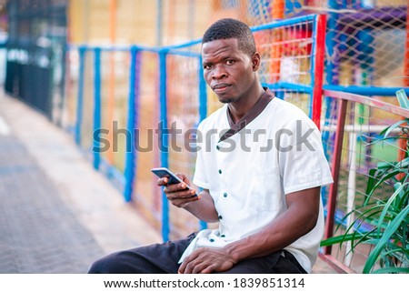 image of african guy, with smart phone- outdoor concept 