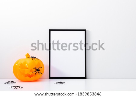 Halloween holiday concept. Photo frame, pumpkin, halloween decorations on white background. Front view, copy space
