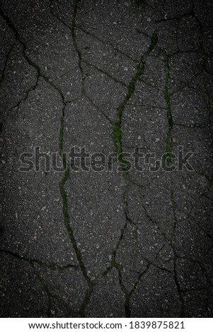 Texture of cracked gray asphalt