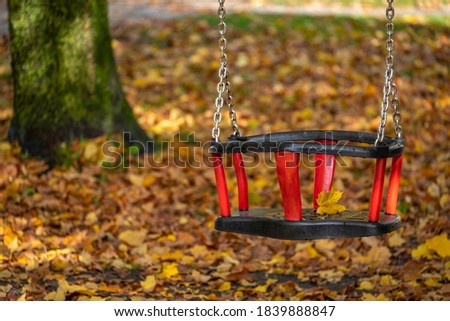red swing on a playground in Lochau