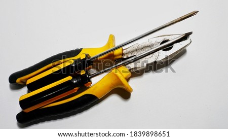 Tools for daily use such as pliers and screwdrivers on a white background