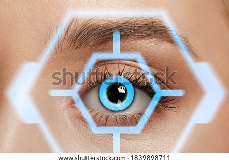 Close up. Future woman with cyber technology eye panel, cyberspace interface, ophthalmology concept. Beautiful female eye with modern identification, medical treatment for focus. Visual effects.