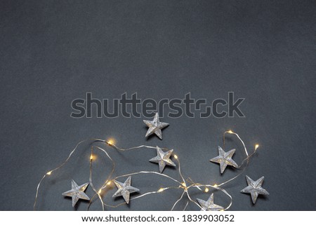 New Year's gray photophone with Christmas garland and stars