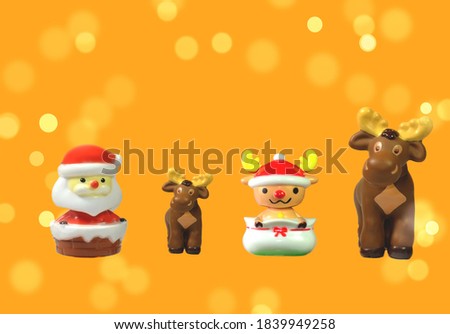 Santa Claus doll, deer, merry Christmas decoration on a bokeh light background 