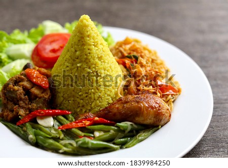 Delicious and tasty Yellow Rice with chicken and vegetables Royalty-Free Stock Photo #1839984250