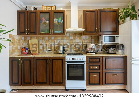 Kitchen set for dark wood in a standard apartment Royalty-Free Stock Photo #1839988402