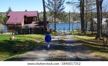kid walking through to ocean at cottage, Mahoney Bay, Halifax 
