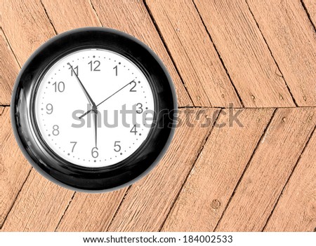 Wall Clock on Wooden Background