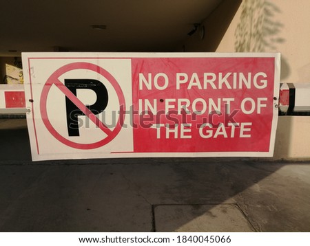 No parking in front of the gate sign.