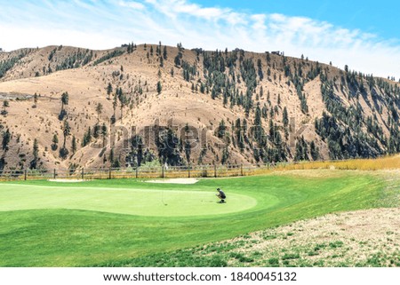 a golfer reading the green