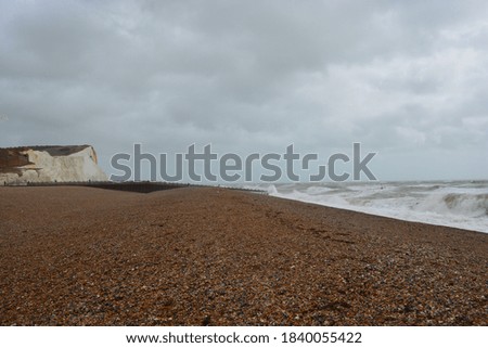 A view a white cliffs and waves at stormy sea