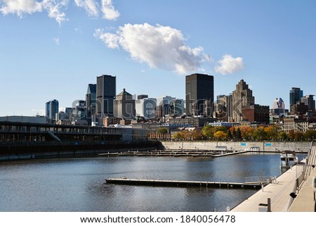View of Montreal from the old port, skyscrapers, old buildings and a pier on the river, Quebec, Canada