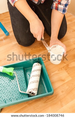 Closeup shot of woman painter doing renovation with tools