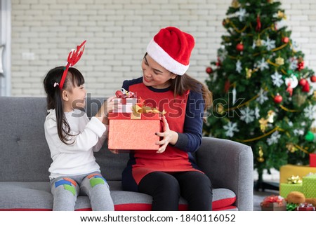mother and cute daughter feeling happy and enjoy with Christmas gift
