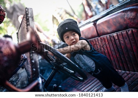 Children take pictures with cars at the museum iron cars in thailand