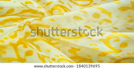 Silk fabric, golden pastels of delicate exquisite colors on a white background, Printed golden paisley photograph. Texture, pattern, collection