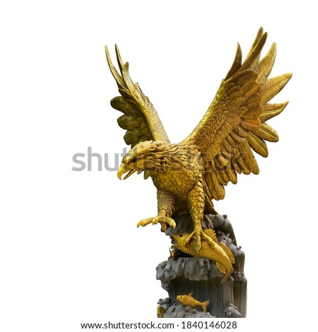 The golden eagle statue spreads its wings to catch fish on the rock. isolated on white background. This has clipping path. Royalty-Free Stock Photo #1840146028