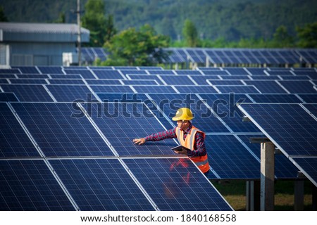 Engineers or workers are inspecting solar panels, engineers and solar power generation stations. Royalty-Free Stock Photo #1840168558