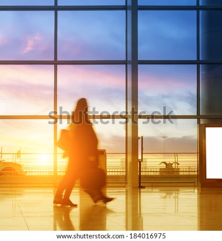 Silhouette of luggage walking at airport