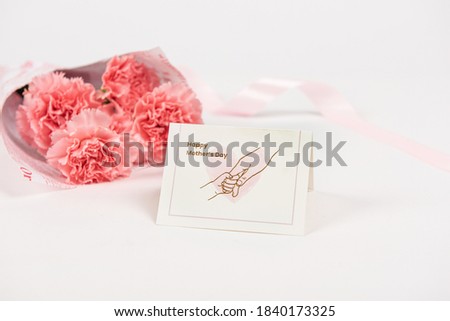 Pink carnations flower with card on white background.Happy Mother‘s day