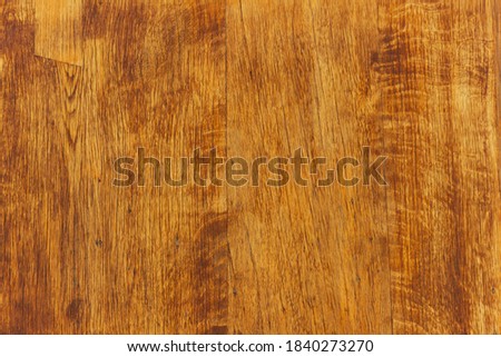 Texture of lacquered wood planks painted in brown.