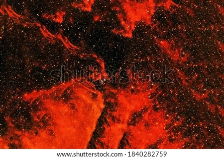Red galaxy with stars and nebulae. Elements of this image furnished by NASA were.