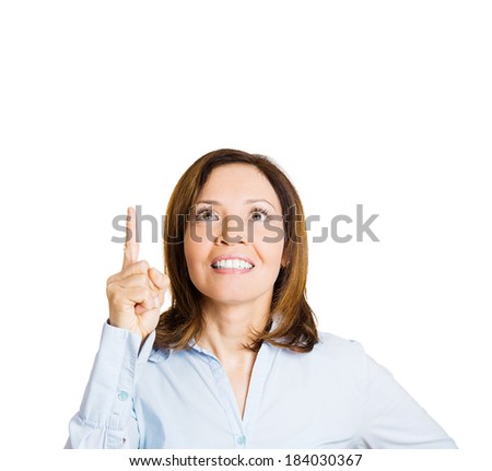 Closeup portrait, young business woman  pointing up, looking at something above showing with index finger, isolated white background. Positive human emotion, facial expression, feeling, symbols, signs