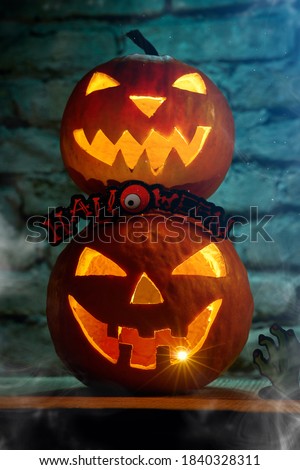 Halloween pumpkin with a carved face and burning candle