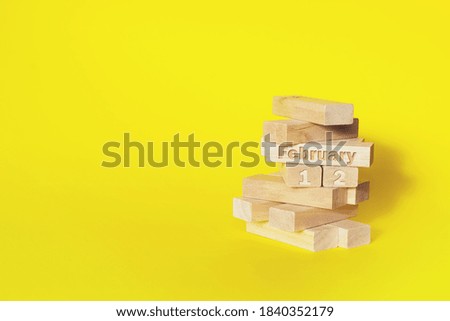 February 12nd. Day 12 of month, Calendar date. Wooden blocks folded into the tower with month and day on yellow background, with copy space. Winter month, day of the year concept