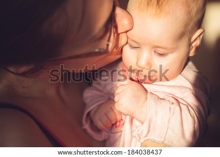 mother kisses the child. bright sunny weather.