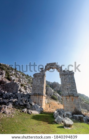 View of the Temple of Zeus in Uzuncaburc, Silifke, Mersin, Turkey. It is situated next to ruins of the ancient city Olba and the name of the town Uzuncaburc means tall bastion referring to the ruins.