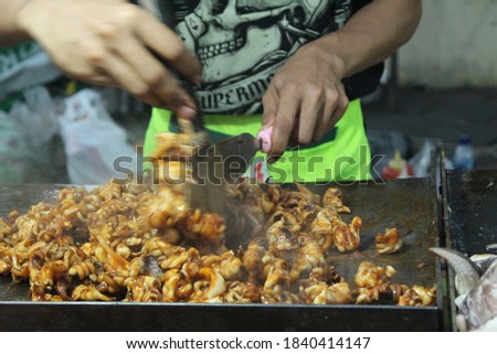 Indonesian street food "Cumi Bakar". Grilled squid. selective focus. grainy picture