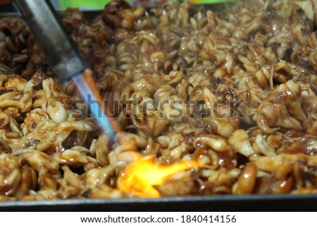 Indonesian street food "Cumi Bakar". Grilled squid. selective focus. grainy picture