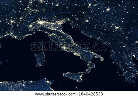 Italy top view from space at night. Map of Italy in satellite picture. Aerial photo of Mediterranean Europe, detail. Dark land and seas, city lights in Italy. Elements of this image furnished by NASA
