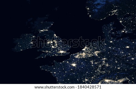 Earth at night, view of UK, Netherlands and Belgium from space. Aerial top view of North Europe part, fragment of world dark map in satellite picture. Elements of this image furnished by NASA Royalty-Free Stock Photo #1840428571