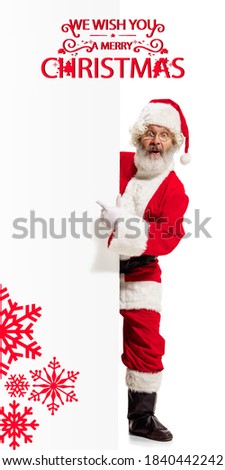 Emotional Santa Claus greeting with New Year 2021 and Christmas. Caucasian man in traditional costume. Concept of holidays and winter mood. Flyer with cpyspace. Stylish senior man with greetings.