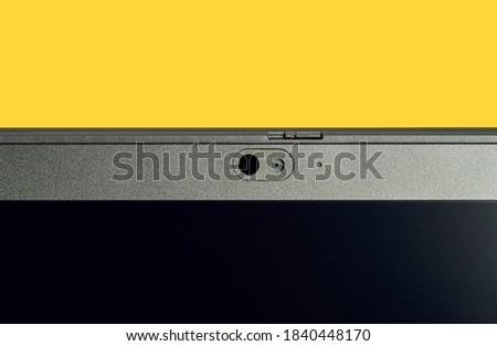 Part of a Computer monitor front,  camera lens. Web Camera on laptop isolated on yellow background