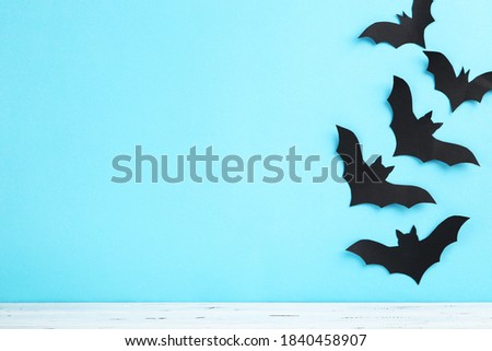 Halloween paper bats on blue background