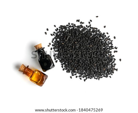 Black cumin oil in small vintage bottle isolated. Caraway seeds organic essential oil, tincture, extract, infusion. Nigella sativa also known as nigella, kalojeere and kalonji tincture, essence